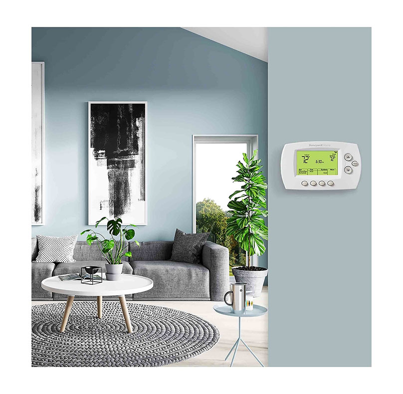 Honeywell 5000 Thermostat on a wall by a living room